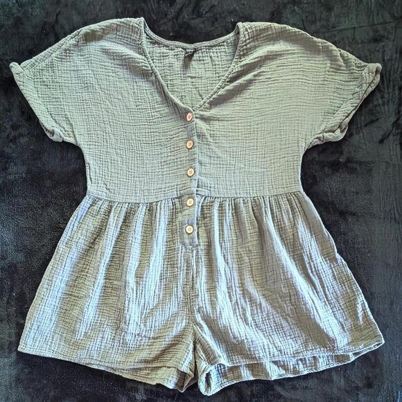 Large sage green romper featuring a v-neckline and five functional buttons down - Picture 1 of 2